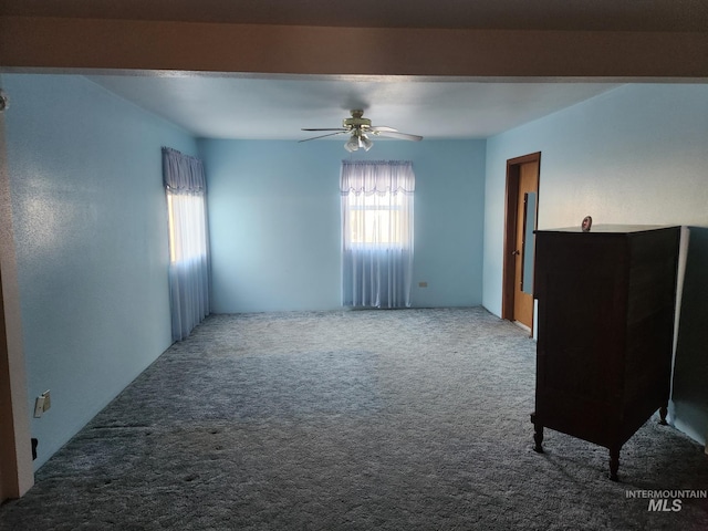 carpeted spare room with ceiling fan