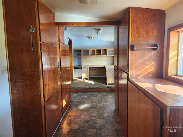 hallway with lofted ceiling