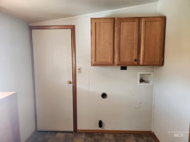 washroom with hookup for a washing machine, wooden walls, and cabinets