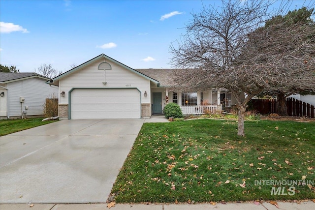 view of front of house featuring a porch, a garage, and a front yard