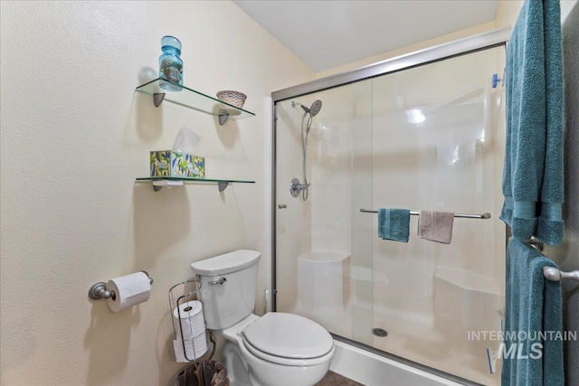 bathroom with walk in shower and toilet