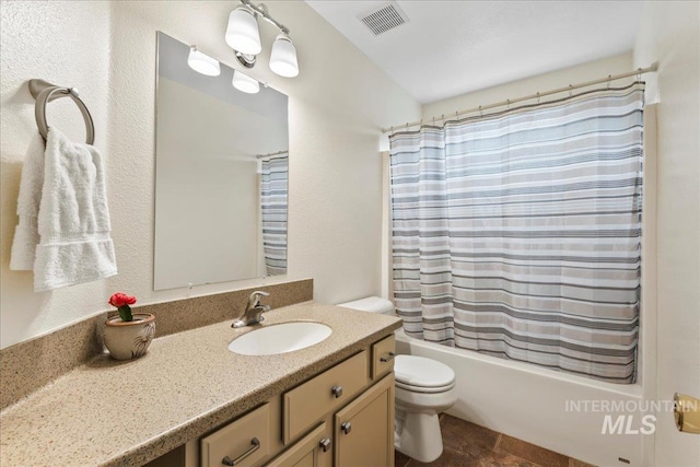 full bathroom with vanity, shower / bath combination with curtain, and toilet