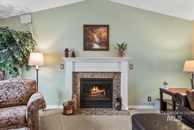 interior space with a tiled fireplace, light carpet, and vaulted ceiling