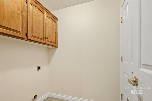 8613 W Thunder Mountain Dr, Boise, ID 83709 - laundry area with electric dryer hookup, cabinet space, and baseboards