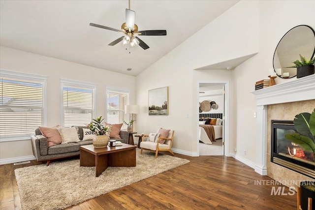 8613 W Thunder Mountain Dr, Boise, ID 83709 - living area with a tile fireplace, a ceiling fan, wood finished floors, and baseboards