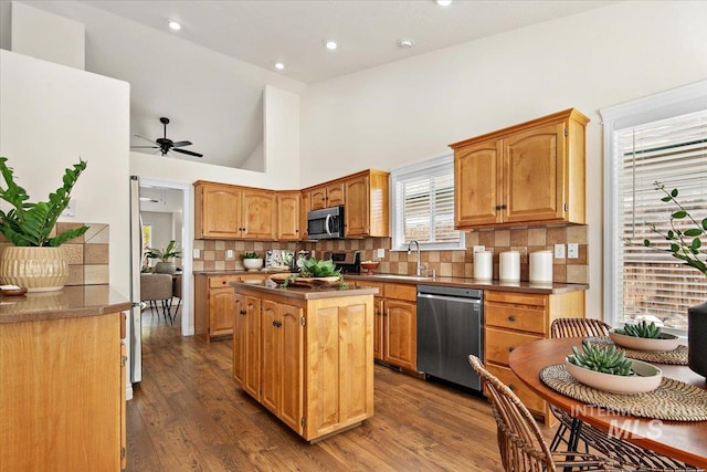 8613 W Thunder Mountain Dr, Boise, ID 83709 - kitchen featuring dark wood finished floors, a center island, ceiling fan, and appliances with stainless steel finishes