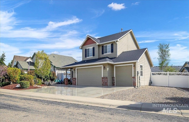 8613 W Thunder Mountain Dr, Boise, ID 83709 - view of front facade featuring fence, concrete driveway, and a garage