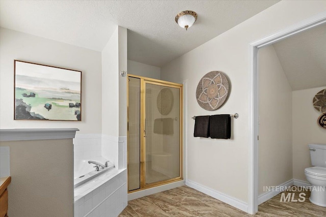 8613 W Thunder Mountain Dr, Boise, ID 83709 - bathroom with a shower stall, toilet, a bath, baseboards, and a textured ceiling