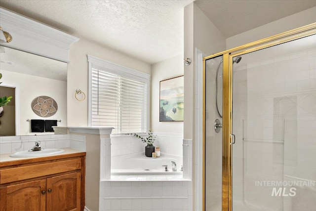 8613 W Thunder Mountain Dr, Boise, ID 83709 - bathroom featuring a stall shower, a textured ceiling, a bath, and vanity
