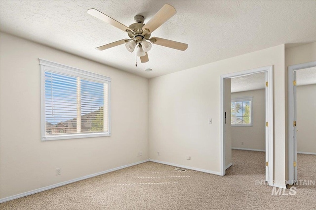 8613 W Thunder Mountain Dr, Boise, ID 83709 - unfurnished bedroom featuring baseboards, a ceiling fan, light carpet, and a textured ceiling