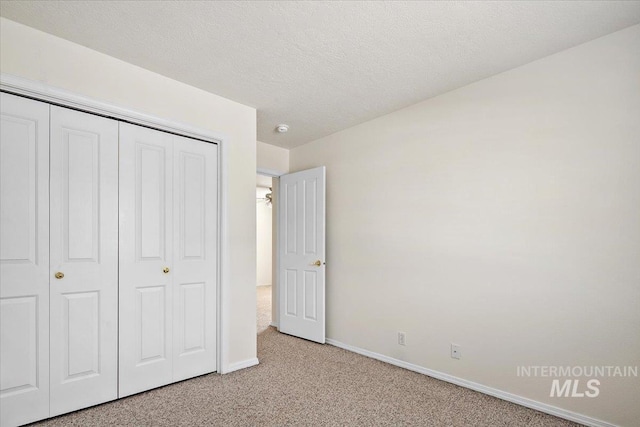 8613 W Thunder Mountain Dr, Boise, ID 83709 - unfurnished bedroom with a closet, a textured ceiling, light colored carpet, and baseboards