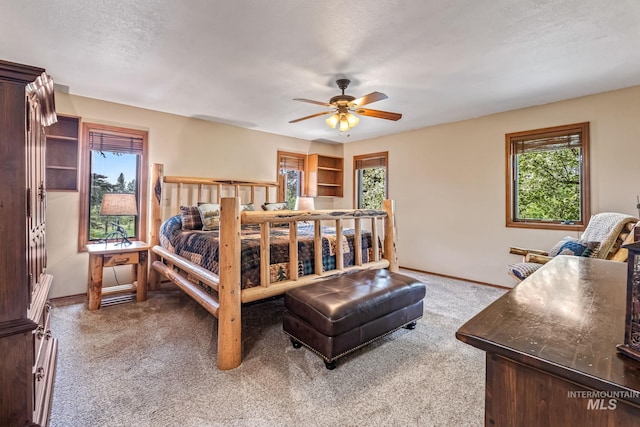 14060 Deerfield, Mccall, ID 83638 - bedroom featuring carpet flooring, baseboards, multiple windows, and a ceiling fan