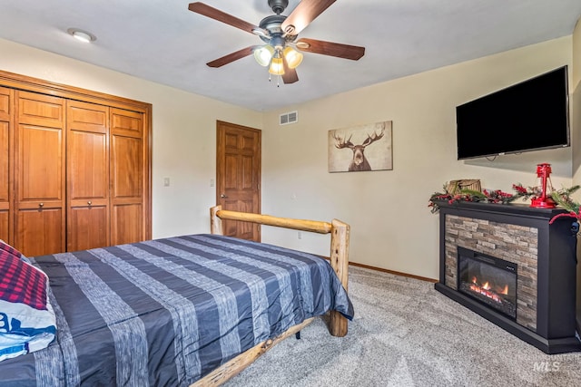 14060 Deerfield, Mccall, ID 83638 - bedroom with light colored carpet, ceiling fan, baseboards, and a stone fireplace