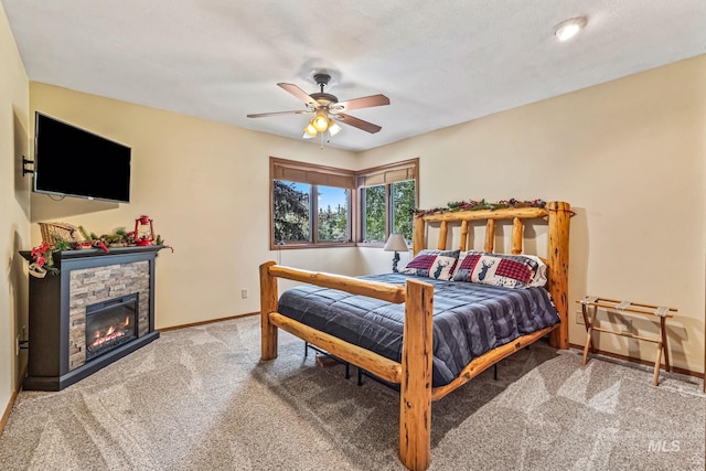 14060 Deerfield, Mccall, ID 83638 - bedroom featuring carpet floors, baseboards, ceiling fan, and a fireplace
