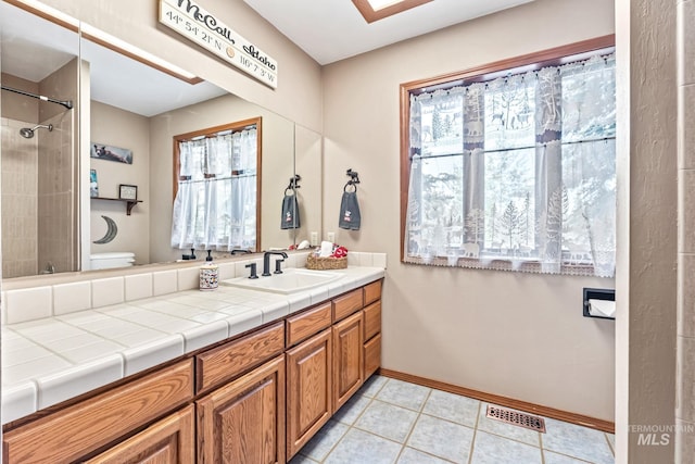 14060 Deerfield, Mccall, ID 83638 - bathroom with toilet, vanity, a shower, tile patterned floors, and baseboards