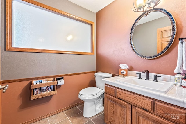 14060 Deerfield, Mccall, ID 83638 - half bathroom featuring toilet, vanity, and tile patterned floors