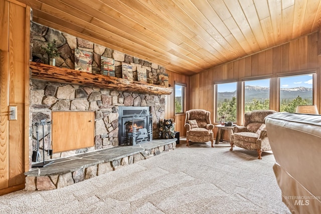 14060 Deerfield, Mccall, ID 83638 - living room featuring vaulted ceiling, wooden ceiling, carpet floors, a stone fireplace, and a mountain view