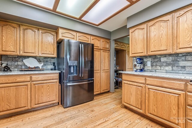 14060 Deerfield, Mccall, ID 83638 - kitchen featuring fridge with ice dispenser, backsplash, and light wood-type flooring