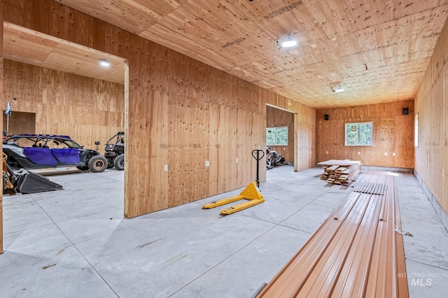 14060 Deerfield, Mccall, ID 83638 - spare room featuring wood walls and concrete floors
