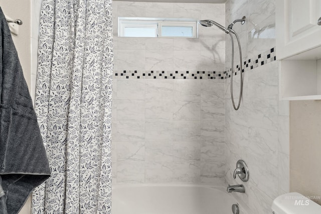 bathroom with toilet and shower / bath combo with shower curtain