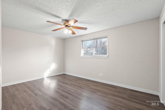 unfurnished room featuring ceiling fan, dark hardwood / wood-style floors, and a textured ceiling