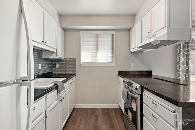 kitchen with sink, white refrigerator, white cabinets, and stainless steel electric range