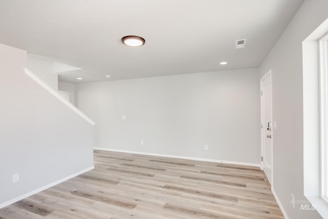 below grade area featuring recessed lighting, visible vents, light wood-style flooring, and baseboards