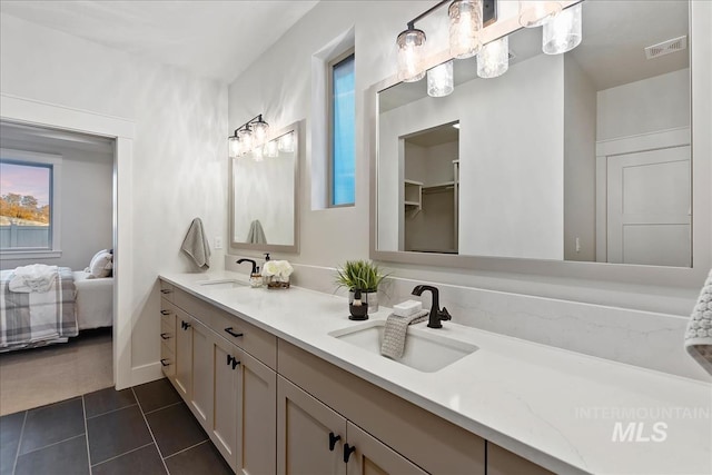 bathroom with tile patterned floors and vanity