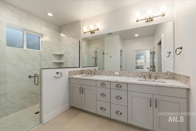 bathroom with tile patterned floors, an enclosed shower, and double sink vanity