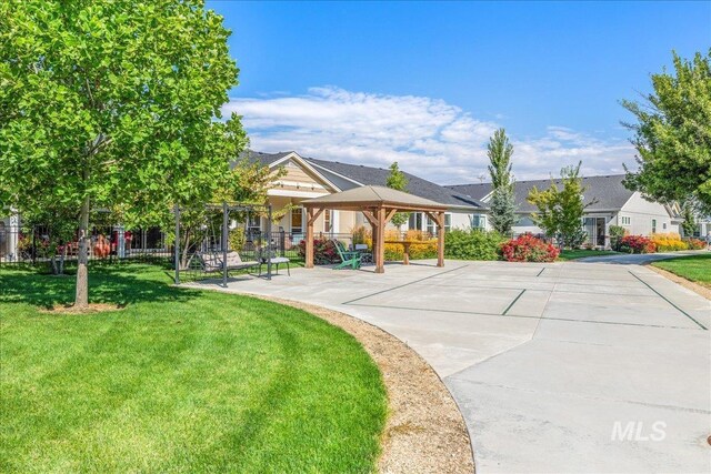 view of front of house featuring a front lawn and a gazebo