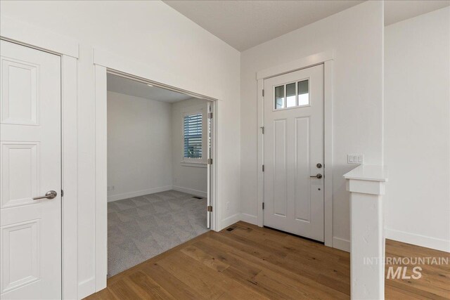 view of carpeted entrance foyer