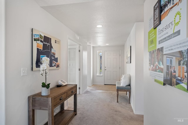 carpeted foyer featuring baseboards and recessed lighting