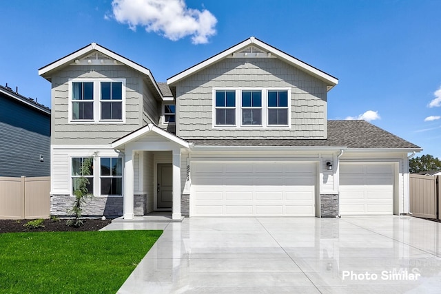 18312 N Rain Dance Way, Nampa, ID 83687 - craftsman-style house featuring fence, stone siding, and driveway