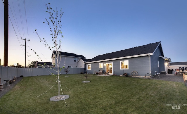 1635 Trail Way, Weiser, ID 83672 - back of property at dusk featuring a fenced backyard and a patio