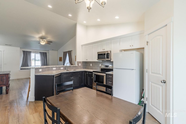 kitchen featuring ceiling fan, kitchen peninsula, white cabinetry, and stainless steel appliances