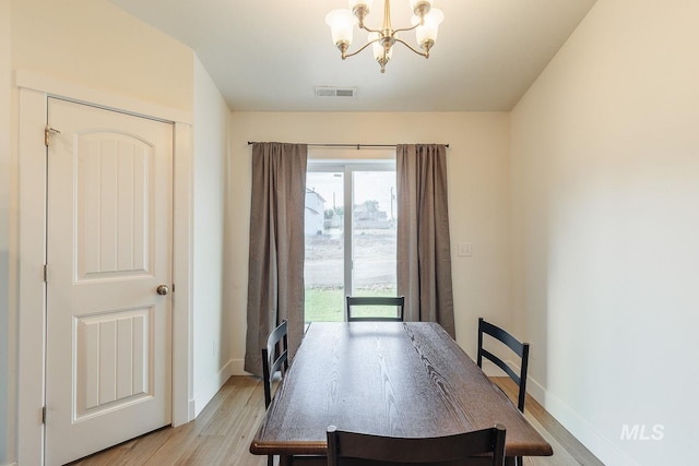 dining room with a chandelier and light hardwood / wood-style floors