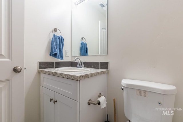 bathroom featuring toilet and vanity