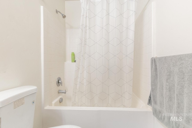 bathroom with toilet and shower / tub combo