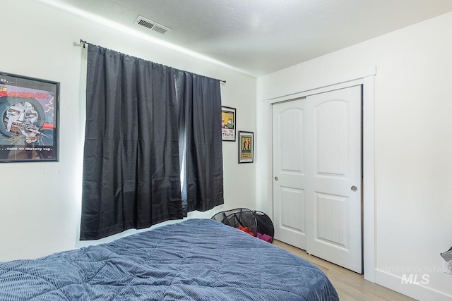 bedroom featuring a closet and light hardwood / wood-style floors