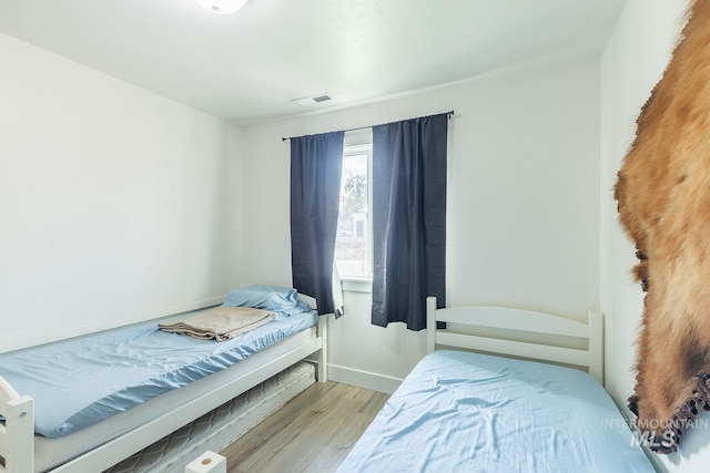 bedroom with light hardwood / wood-style flooring