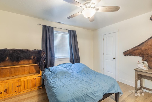 bedroom with ceiling fan and light hardwood / wood-style floors