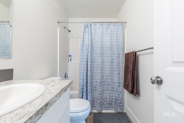 full bathroom featuring toilet, vanity, and shower / bath combo with shower curtain