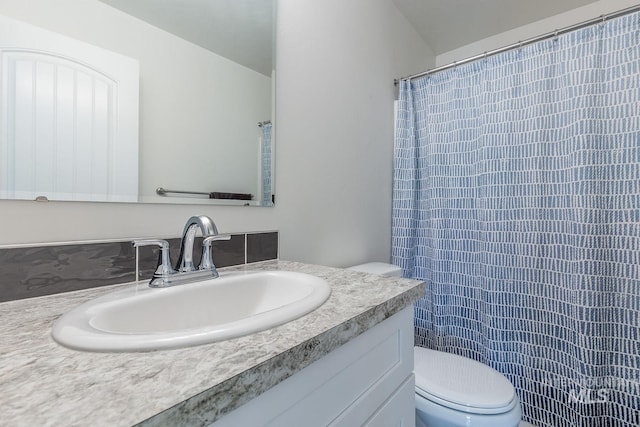 bathroom featuring toilet, a shower with curtain, and vanity