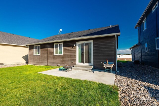 back of property featuring a patio area, central air condition unit, and a yard