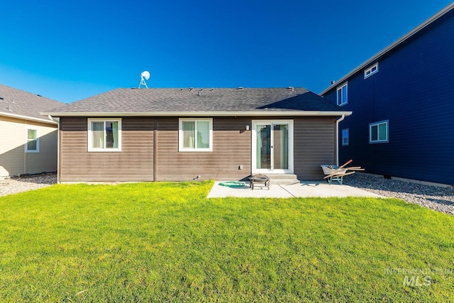 rear view of property with a yard and a patio