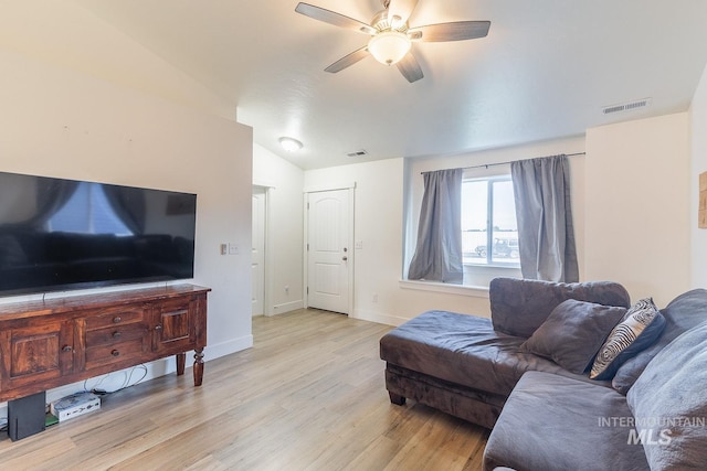 living room with ceiling fan, lofted ceiling, and light wood-type flooring