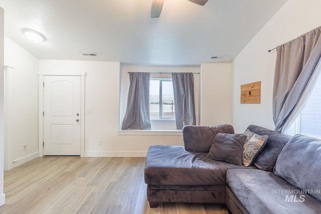 living room featuring ceiling fan and light wood-type flooring