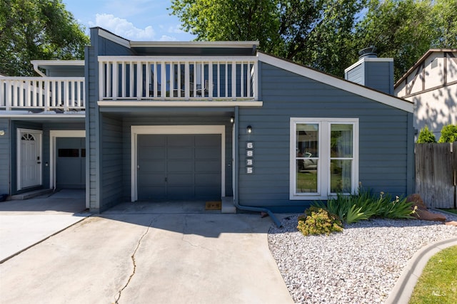 6835 W Freemont St, Boise, ID 83704 - view of front of house with a balcony, a garage, driveway, and a chimney