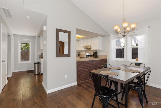 6835 W Freemont St, Boise, ID 83704 - dining area featuring a chandelier, dark wood-style floors, and vaulted ceiling