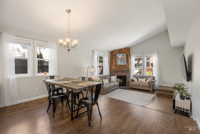 6835 W Freemont St, Boise, ID 83704 - dining room with a fireplace, dark wood-style floors, a chandelier, and vaulted ceiling
